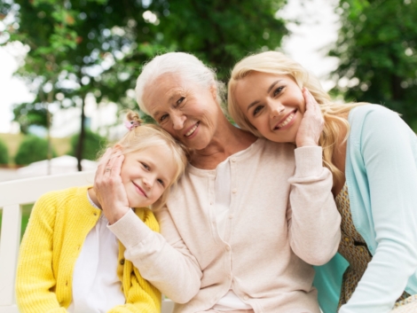 family, generation and people concept - happy smiling woman with daughter and senior mother sitting on park bench