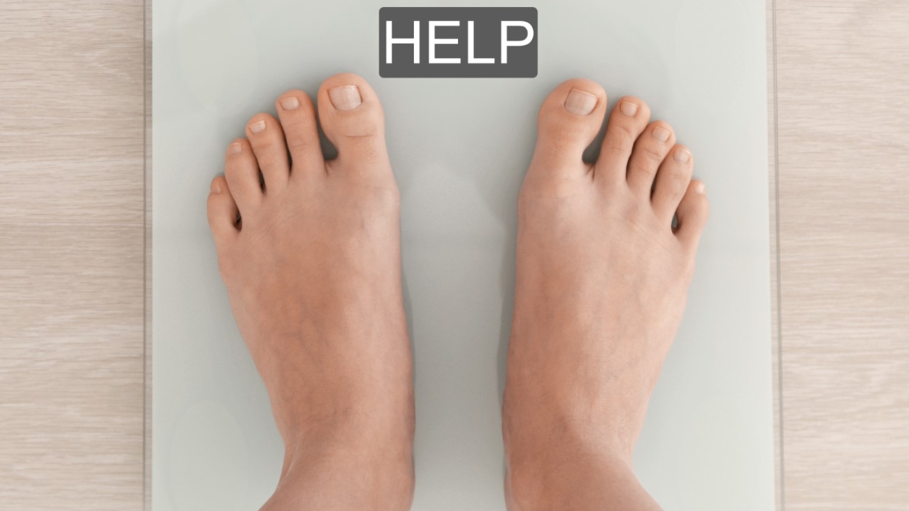 Diet concept. Female bare feet standing on scales