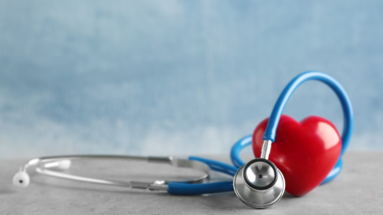 Stethoscope and red heart on table